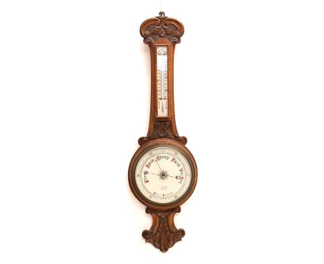 Early 20th century carved oak aneroid barometer and thermometer, 85cm high