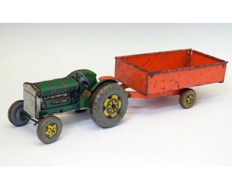Mettoy Playthings tinplate clockwork tractor with red trailer