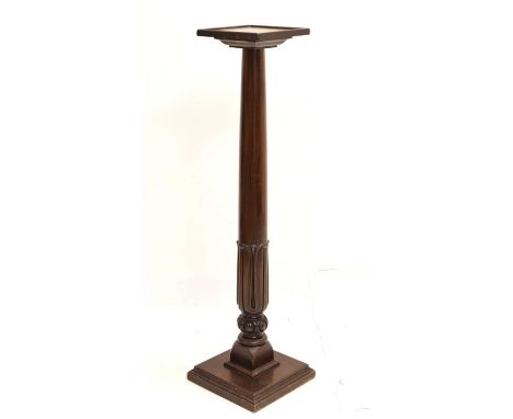 Early 20th century mahogany torchère/plant stand having a carved lower-section pillar, raised on a square step base, 26cm x 2
