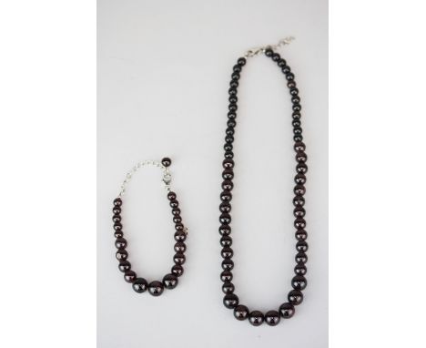 A graduated red jade bead necklace and matching bracelet with 925 silver fittings.