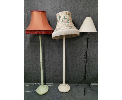 Two painted vintage wooden standard lamps with a wrought iron standard lamp.