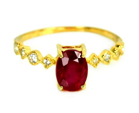 A 925 silver gilt ring set with an oval cut ruby and white stones, (L).