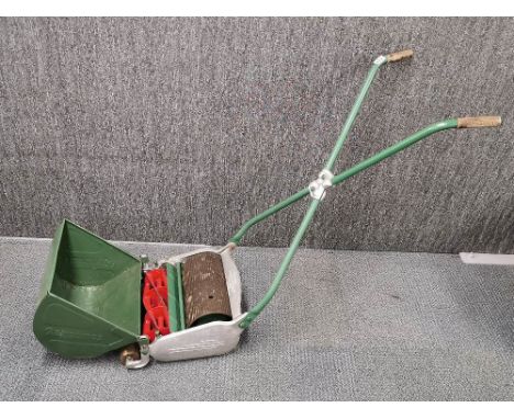 A vintage Ransomes push lawn mower.