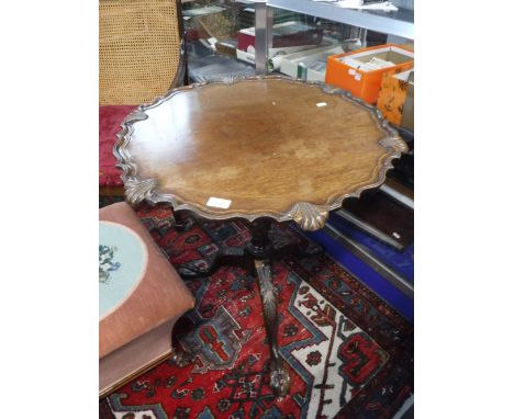 A MAHOGANY CHIPPENDALE STYLE TRIPOD TABLE with carved legs and piecrust edge, 26" dia.