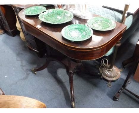 A REGENCY ROSEWOOD 'D' SHAPED FOLD-OVER TOP CARD TABLE on quadruple supports with downswept legs, 36" wide