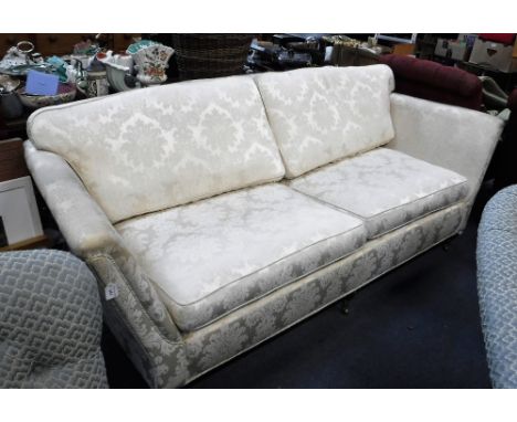 A SOFA OF TRADITIONAL DESIGN upholstered in cream damask, 88" wide