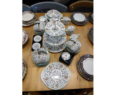 A MINTON'S BONE CHINA HADDON HALL TEASET designed by John Wadsworth, comprising teapot, milk jug, sugar bowls, teacups, sauce