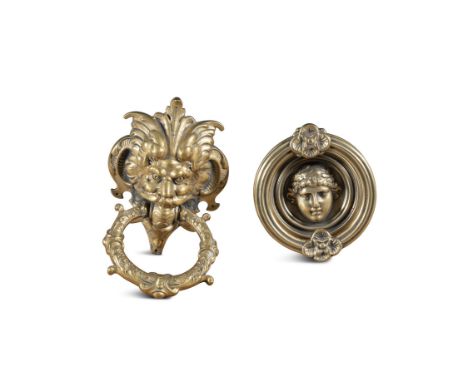 A CAST BRASS DOOR KNOCKER, in the form of a grotesque mask. with leaf ring knocker, engraved verso 'Schultz' 18cm high; toget