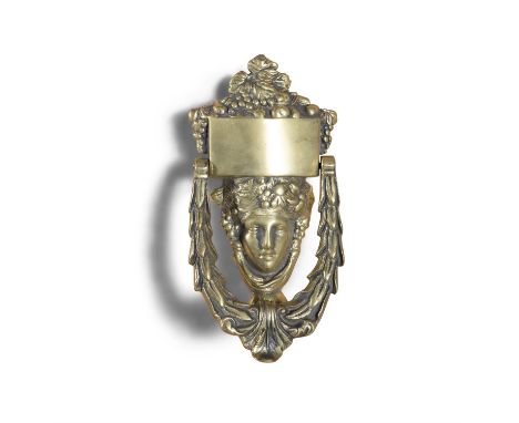 A CAST BRASS DOOR KNOCKER, in the form of a classical female mask surmounted by fruiting vines with wreath knocker, 21cm high