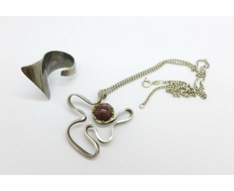 A hallmarked silver designer ring, J. Millward Banks, K/L, and a hallmarked silver designer pendant on a silver chain, maker 