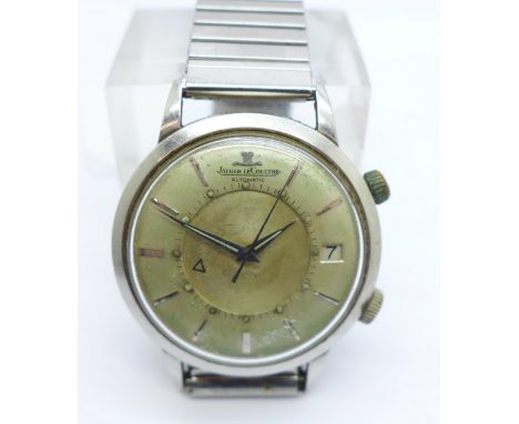 A Jaeger-LeCoultre automatic Memovox alarm and date wristwatch, calibre 825, model E855, 882584, with guarantee certificate d