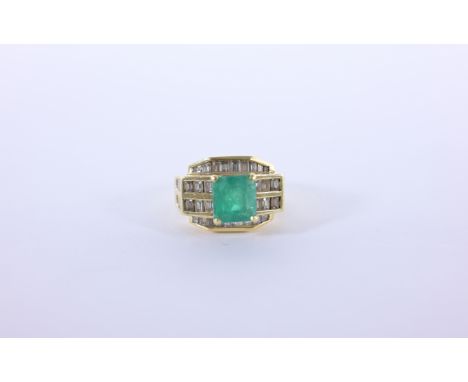 18K Gold Emerald & Diamond Ring. Center emerald surrounded by 42 baguette cut diamonds. Stamped inside band. Ring Size: 9.25T