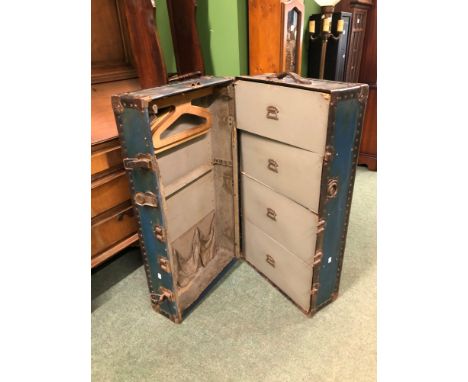 A VINTAGE METAL BOUND TRAVELLING TRUNK