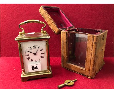 A BRASS CASED CARRIAGE CLOCK WITH A OUTER LEATHER CASE.