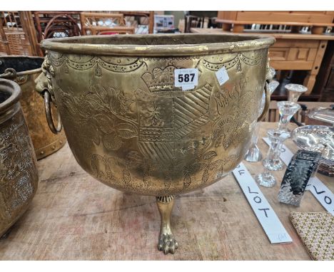 A BRASS LION AND RING HANDLED TRIPOD WOOD BUCKET