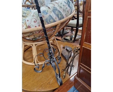 A WROUGHT IRON TRIPOD CANDLE STAND, FIRE IRONS AND A PAIR OF FIRE BELLOWS