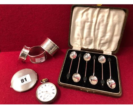 A HALLMARKED SILVER POCKET WATCH, COMPACT, THREE NAPKIN RINGS AND A SET OF SIX COFFEE SPOONS.