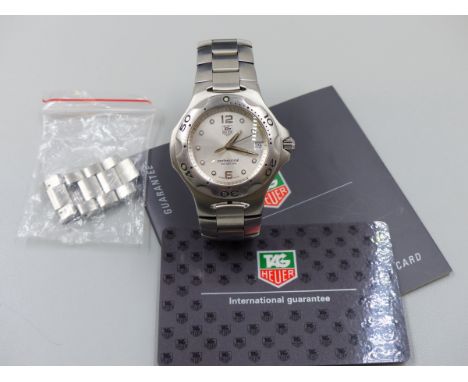A TAG HEUER PROFESSIONAL STAINLESS STEEL WRIST WATCH, MODEL NUMBER WL111E. WORKING, NO GUARANTEE. COMPLETE WITH GUARANTEE CAR