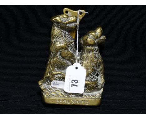     A Cast Brass Twin Dog Door Knocker                                              