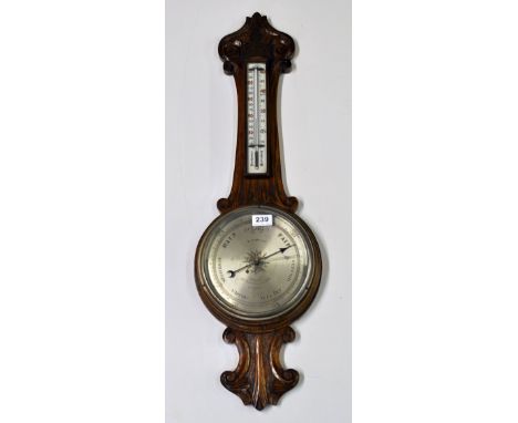 A carved oak barometer and thermometer by W. Johnson, London.