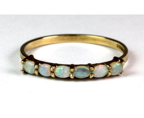 A 9ct gold opal half eternity ring, (N.5).