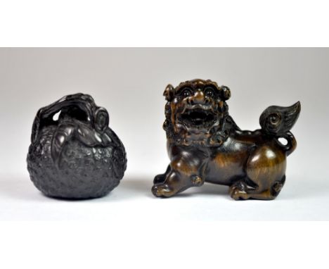 Two fine carved fruitwood netsuke of a lion-dog and a lychee.
