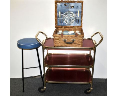 A vintage picnic set with a tea trolley and bar stool.