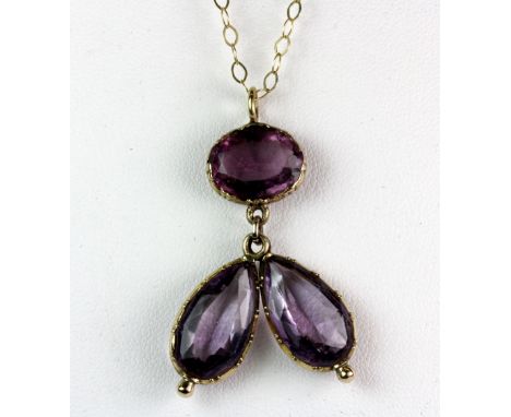 An unusual yellow metal (tested 9ct gold) and amethyst pendant on an 9ct gold chain.
