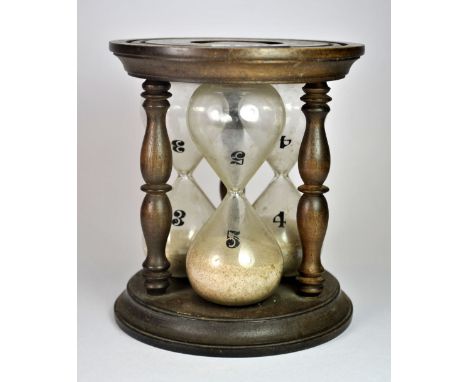 An unusual early 20th century wood and blown glass egg timer, marked for 3, 4 and 5 minutes, H. 15 cm.