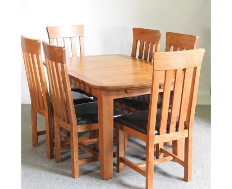 A modern light oak extending dining table, with a set of six dining chairs with brown leather seats (7)139 x 90cm closed