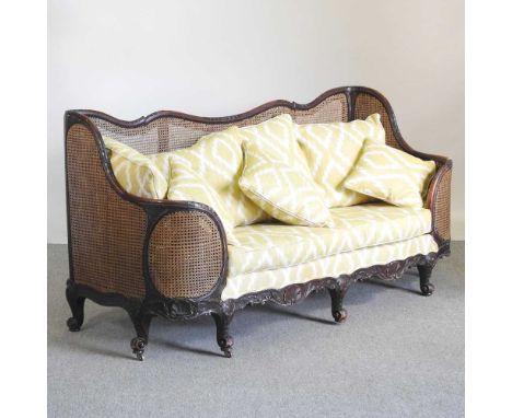 An early 20th century double cane bergere sofa, with yellow upholstery by Merryweather186w x 72d x 93h cmOverall condition is