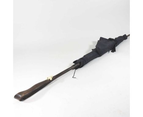 An early 20th century Japanese parasol, the handle carved to simulate a leather strap, decorated with an ivory frog and an in