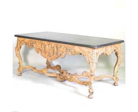 A large continental carved wood centre table, 20th century, the rectangular marble top, on an ornate shell and scroll carved 