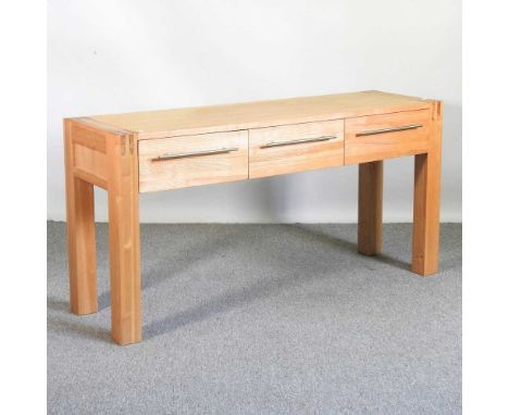 A modern light oak console table, containing three drawers150w x 45d x 75h cm
