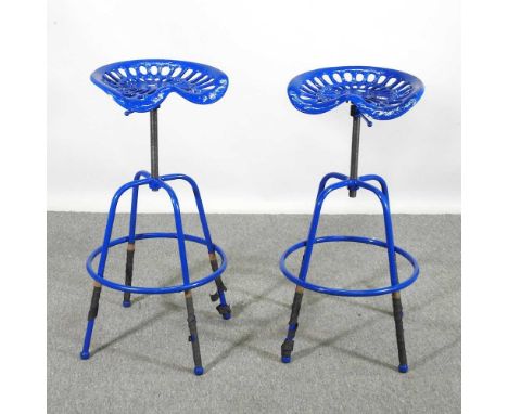 A pair of blue painted metal tractor seat bar stools (2)