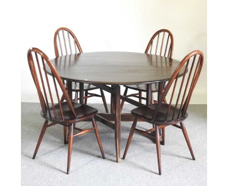 An Ercol dark elm drop leaf dining table, together with a set of four hoop back dining chairs (5)