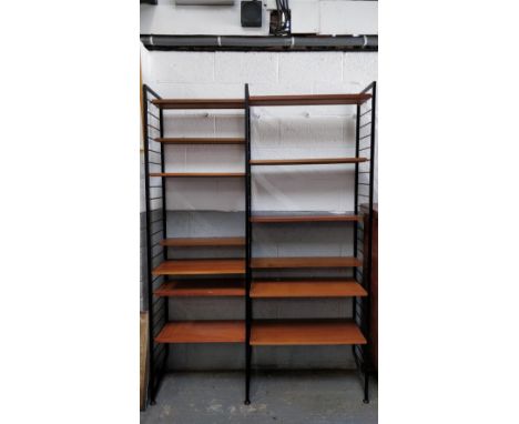 A 1970's ladder shelving unit, with 12 adjustable shelves, 221cm high, 140cm wide, 35cm deep