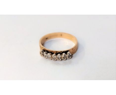 A seven stone diamond half hoop ring, the illusion set single cuts to a shank stamped '14K', finger size P, 3.4 g gross