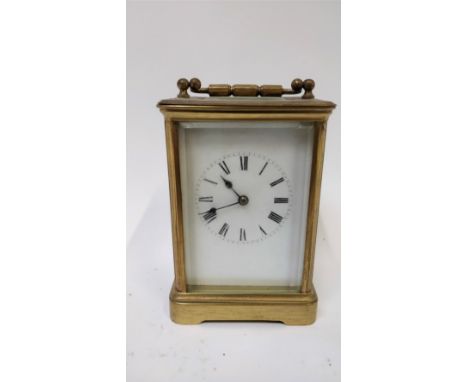 A 20th century carriage clock, white enamel face and roman numerals