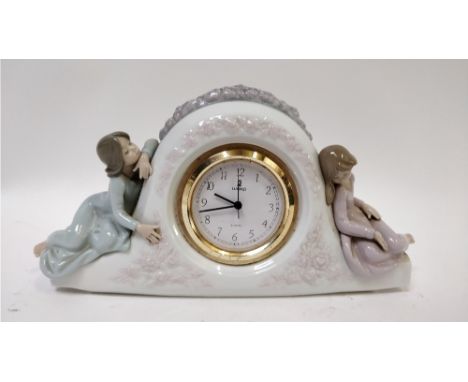A Lladro mantel clock, with a seated girl either side, model number 5776, 53cm long