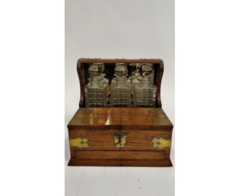 A 20th century oak tantalus, with fitted decanter section, open out lid and single drawer, with brass mounts and a lockable d