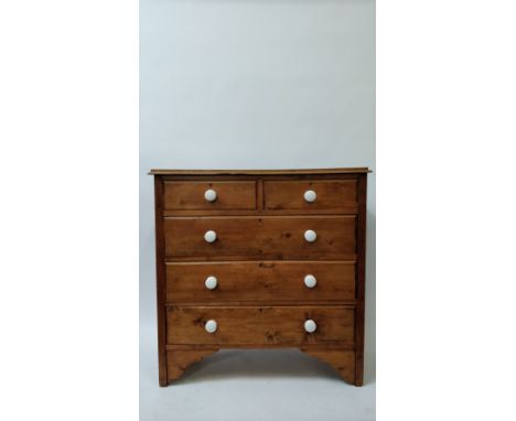 A 20th century pine chest of drawers of two and three long, with white ceramic handles, 108cm high, 107cm long, 45cm deep
