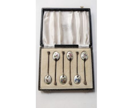 A cased set of six silver gilt and enamel coffee spoons, Birmingham 1960, the bowl backs enamelled with various flowers, 64 g