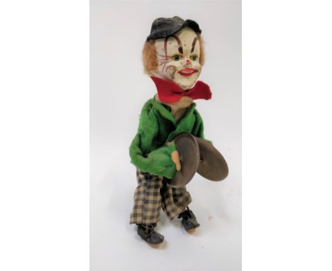 A 20th century German tin plate model of a clown playing cymbals, 22cm high