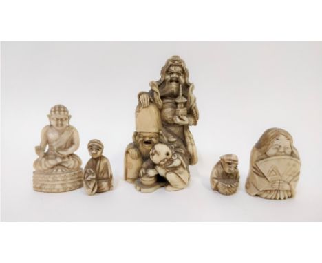 A 19th century ivory netsuke of a standing figure holding pagoda with two other figures, along with an ivory buddha and three