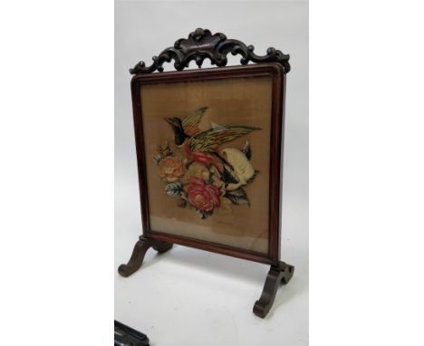 A Victorian firescreen, with a tapestry woolwork of a pheasant in flight, in a mahogany frame, 84cm high, 53cm wide