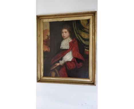 An 18th century English oil on canvas portrait of a seated boy, seated holding a book on grammar, in a gilded frame, 75cm x 5