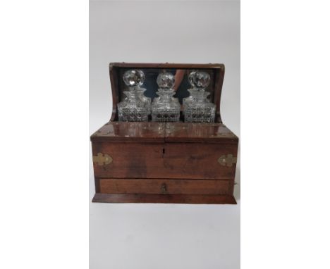 An early 20th century tantalus, in a mahogany frame with fitted section for three decanter, open open out section and single 