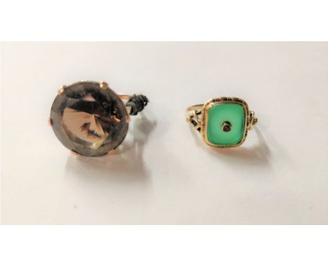 A smoky quartz ring, unmarked; with another ring, also unmarked