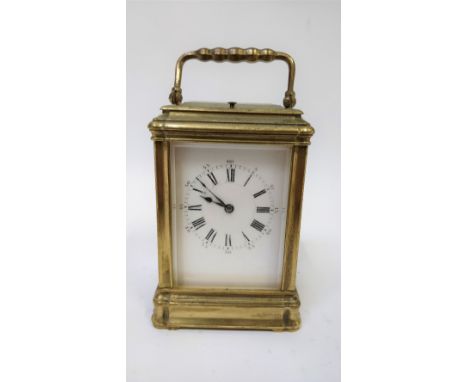 A 20th century French carriage clock, with a white enamelled face and Roman numerals